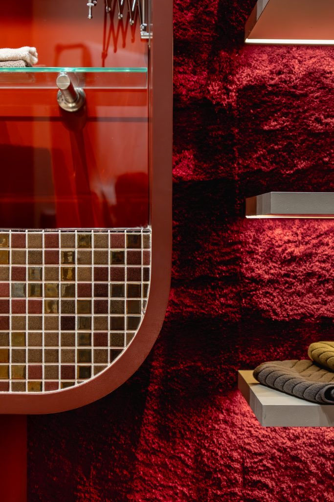 Mosaic tile against the bordeaux carpet of the experience room