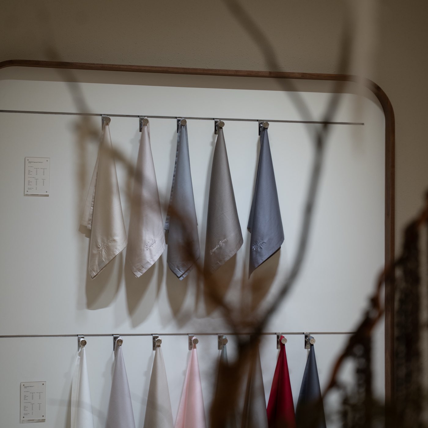 Fabric samples hanging in soft natural shadow